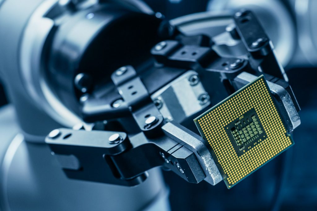 Modern High Tech Authentic Robot Arm Holding Contemporary Super Computer Processor. Industrial Robotic Manipulator End Effector Holding CPU Chip