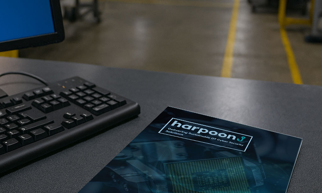 Background image showing the Harpoon Service Brochure sitting on a desk in a factory environment
