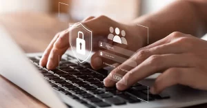 hands typing at a laptop keyboard with a login form overlaid