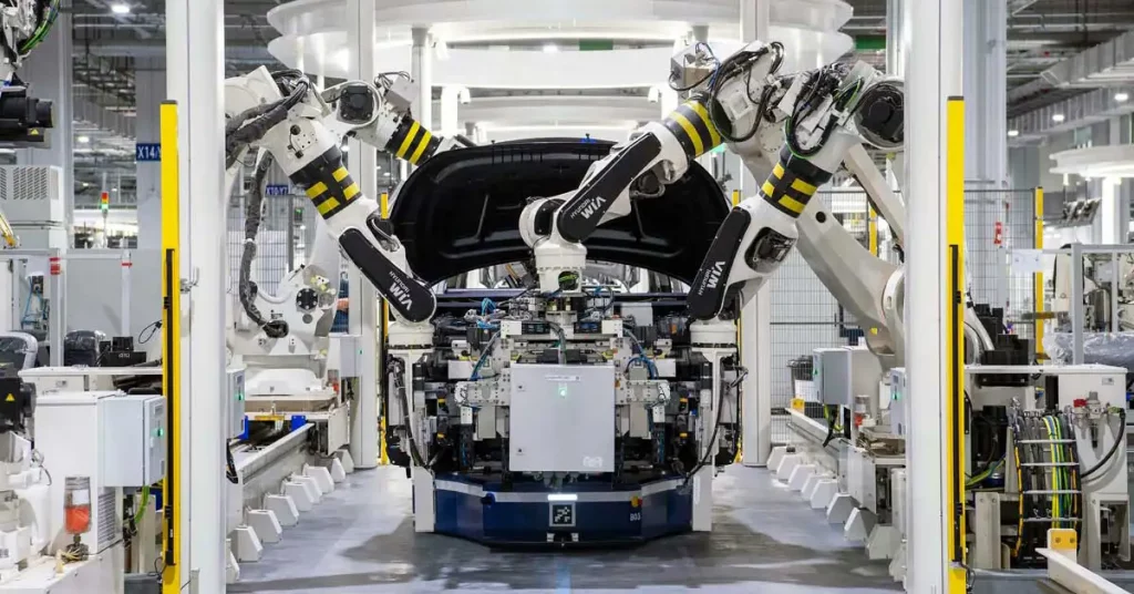 Several robot arms working to assemble a car in a factory