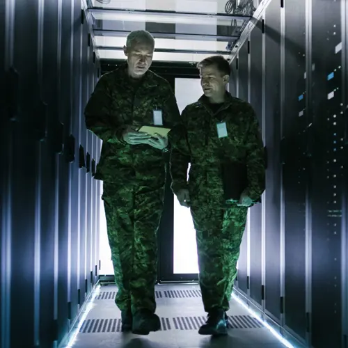 two military personnel walking down a high-tech corridor